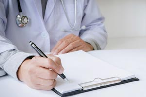 Doctor writing on paper
