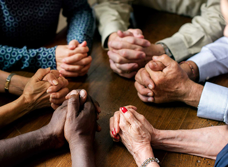 Many hands in prayer